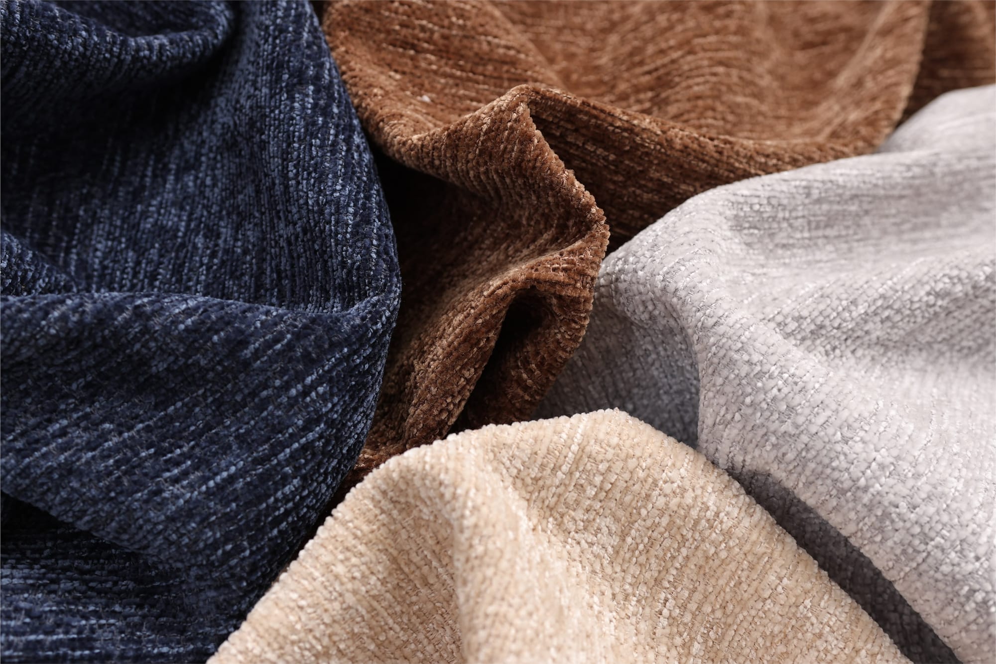 Navy, brown and light grey woven fabrics loosely draped together