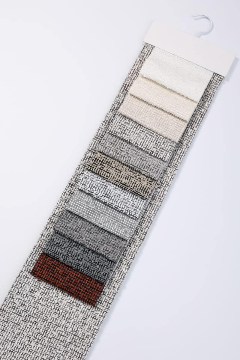 dé sample hanger with woven fabric swatches in greys and neutrals